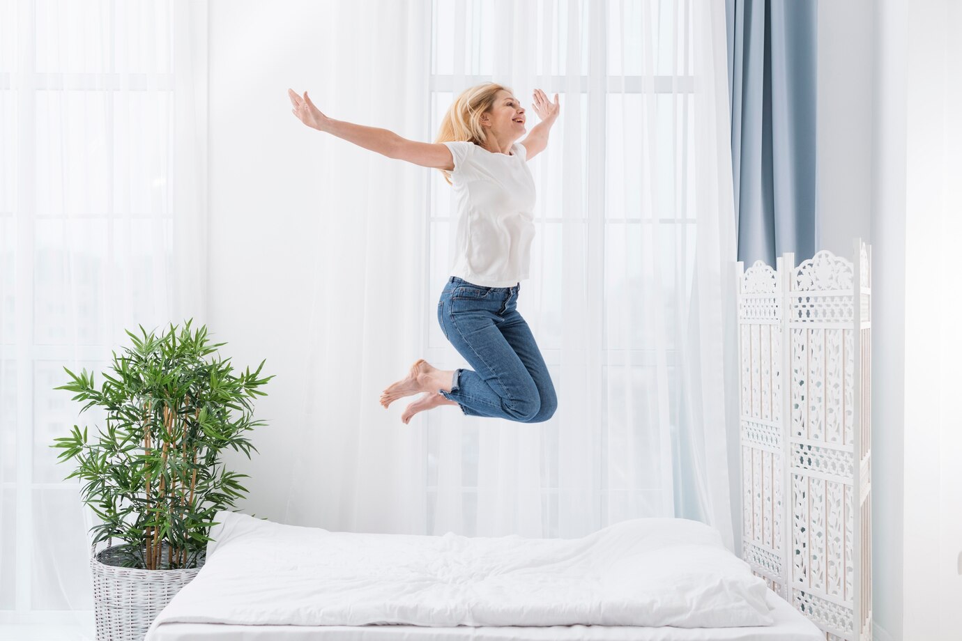 Portrait happy woman jumping bed 23 2148440199